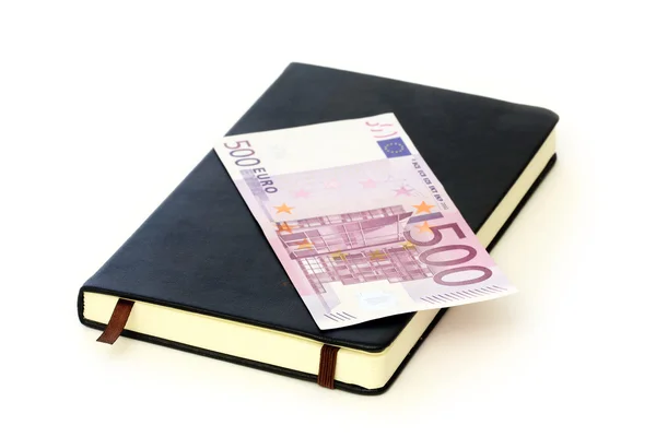 Euro auf Notizbuch isoliert auf weißem Papier — Stockfoto