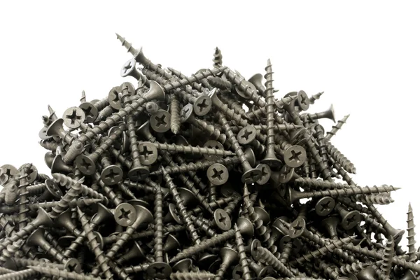 Bir sürü beyaz bir arka plan üzerinde siyah Alçıpan vidaları