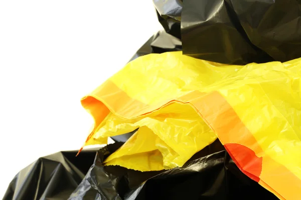 Bolsas de plástico negras y amarillas sobre fondo blanco — Foto de Stock