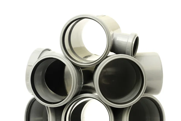 A lot of plastic sewer pipes on white — Stock Photo, Image
