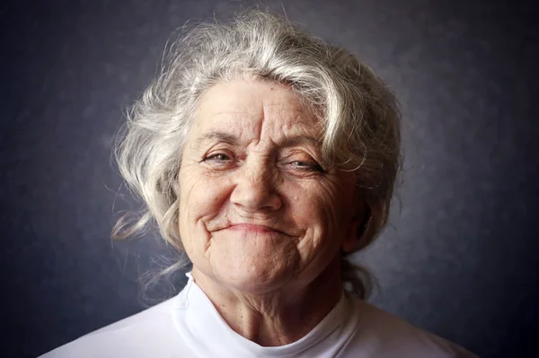 Happy granny portrait on a dark background