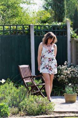 Appreciating a beautiful woman enjoying the green radiance of spring and summer.