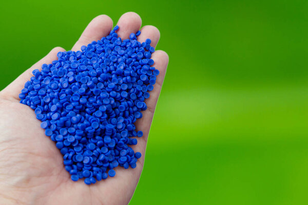 Close-up of plastic polymer granules. hand hold Polymer pellets. polymer plastic. compound polymer.