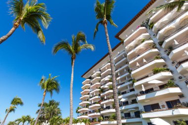 Luxury condominiums and apartments on Playa De Los Muertos beach and pier close to the famous Puerto Vallarta Malecon, the city largest public beach clipart