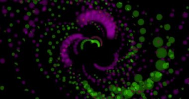 Yeşil ve mor renkli parlayan toplar izleyiciye doğru uçar ve yörüngelerini değiştirir.