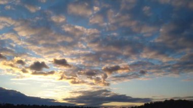 Thunderclouds move across the blue sky over the horizon