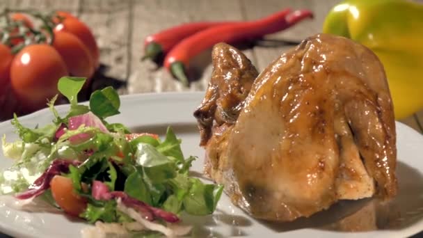 Roast chicken with salad on white plate rotating — Stock Video