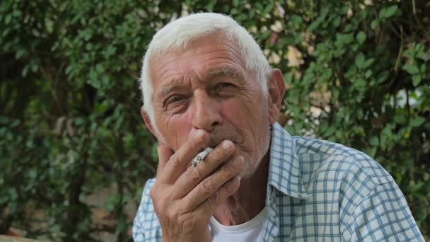 A senior man smoking a cigarette — Stock Video