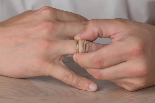 Divorce, separation: man removing wedding or engagement ring — Stock Photo, Image