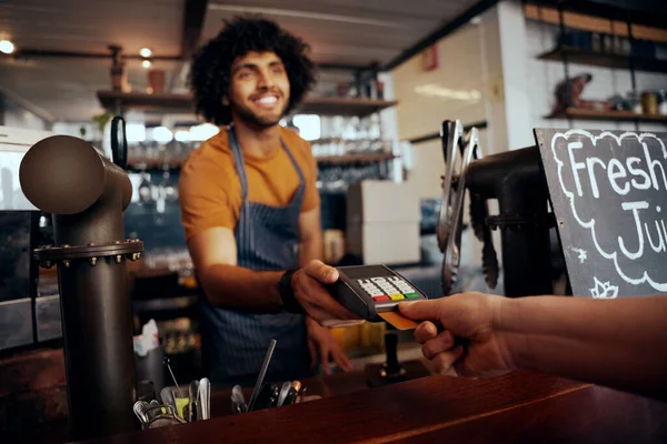 Cameriere in possesso di carta di credito strisciare macchina mentre il cliente digitando codice in moderno caffè — Foto Stock