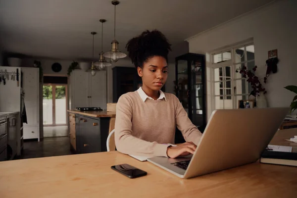 Jovem empreendedor bem sucedido trabalhando em casa no laptop durante o bloqueio do coronavírus — Fotografia de Stock