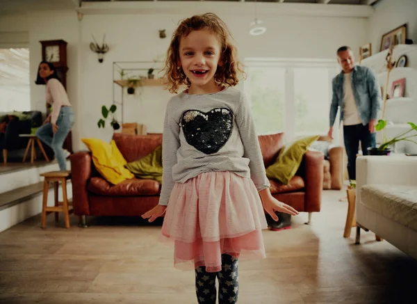 Portrait of smiling girl standing ready to dance at home