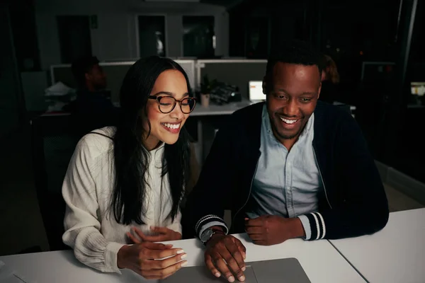 Glada unga skiftande affärskollegor njuter av att arbeta tillsammans på laptop vid skrivbordet på kontoret — Stockfoto
