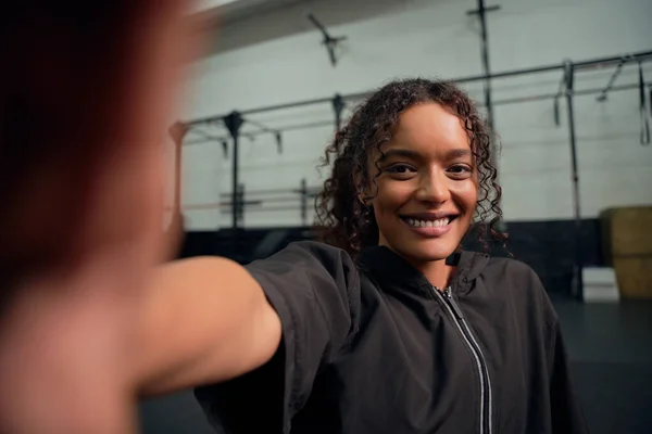 Mulher afro-americana feliz a tirar uma selfie no ginásio. Feliz mestiço feminino sorrindo para a câmera. Foto de alta qualidade — Fotografia de Stock