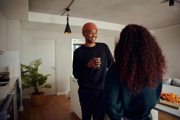 Mixed race couple drinking coffee together. Young, happy African American male smiling at his female partner. High quality photo — Stock Photo, Image