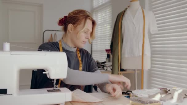 Caucasian female dress designer working in studio using sewing machine — Video