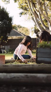 Bahçede annesine yardım eden etnik kökenli bir Asyalı kız. Yüksek kaliteli FullHD görüntüler