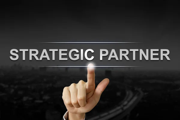Zakelijke hand duwen strategische partner knop — Stockfoto