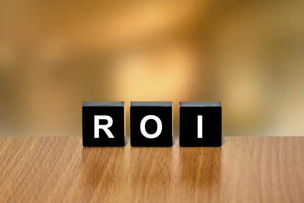 ROI or return on investment on black block — Stock Photo, Image