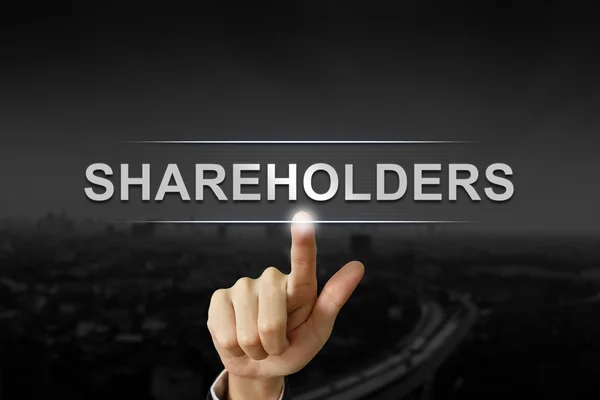 Zakelijke hand aandeelhouders missie knop — Stockfoto
