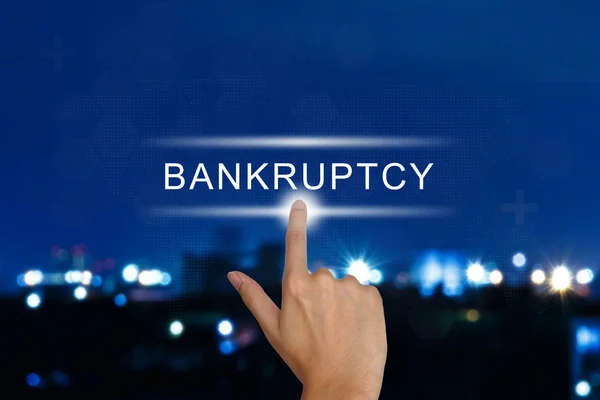 Hand pushing financial bankruptcy button on touch screen — Stock Photo, Image