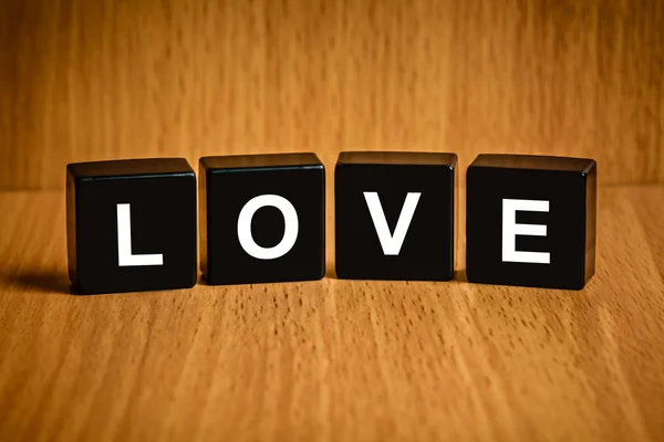 Love word on black block — Stock Photo, Image