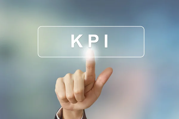 Hand clicking KPI or Key Performance Indicator button on blurred — Stock Photo, Image