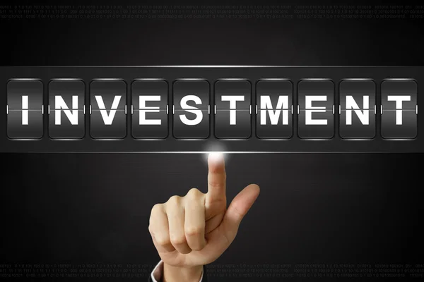 Business hand att klicka på investeringar på blädderblock — Stockfoto