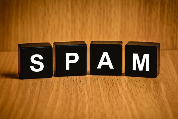 Spam e-mail word on black block — Stock Photo, Image