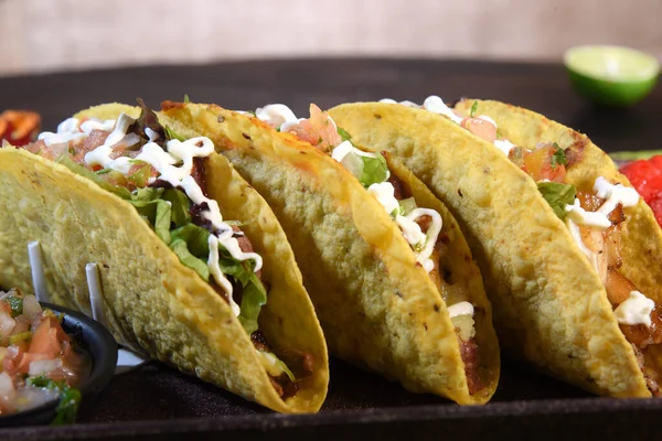 delicious spicy Mexican taco with salad and pepper