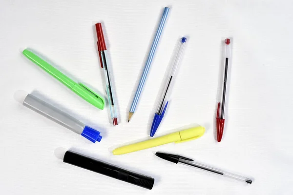 several colored pens used in schools and offices isolated with space for text