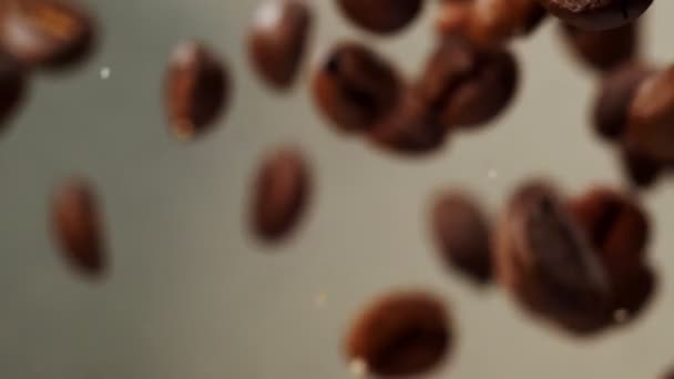 Slow Motion Colpo di chicchi di caffè tostati esplosi su grigio sfumato. — Video Stock