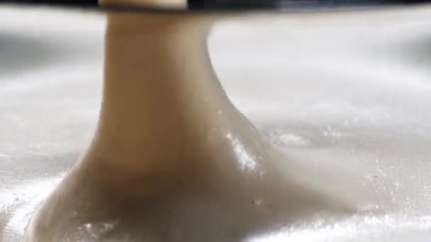 Macro shot of whipping custard and steel whisk. Whisk in white creme — Stock Video