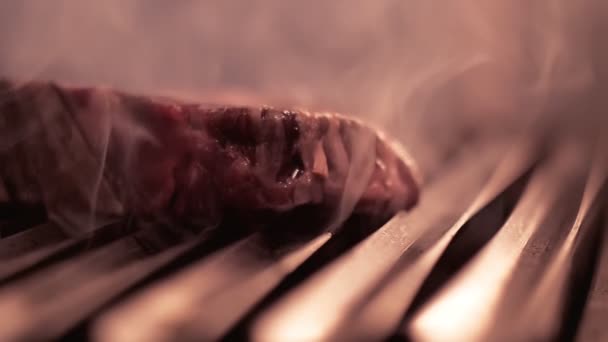 Raw beef steak falls on grill with burning fire and smoke. — Stock Video