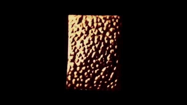 Isolated metal plate with abstract texture rotating on a black background. Abstract reflection on copper plate — Stock Video