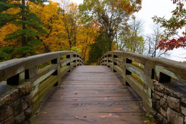 Wooden bridge on a cloudy Autumn morning.  Starved Rock State Park, Illinois, USA clipart