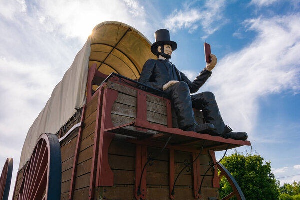 Lincoln, Illinois / United States - September 23rd, 2020:  Covered wagon with Abraham Lincoln on historic Route 66.