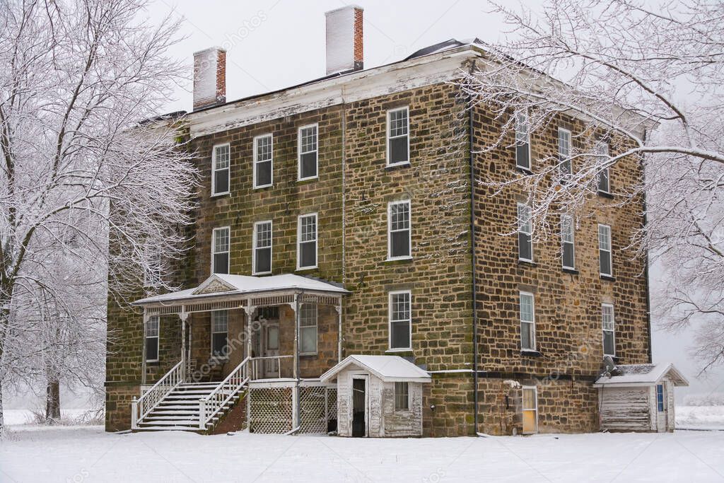 Old stone hotel in the Midwest countryside on a snowy morning.  LaSalle County, Illinois, USA