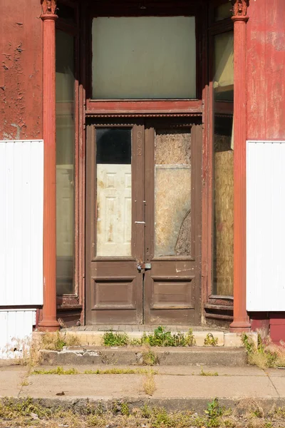 Closed doors on old business building in small town in Iowa.