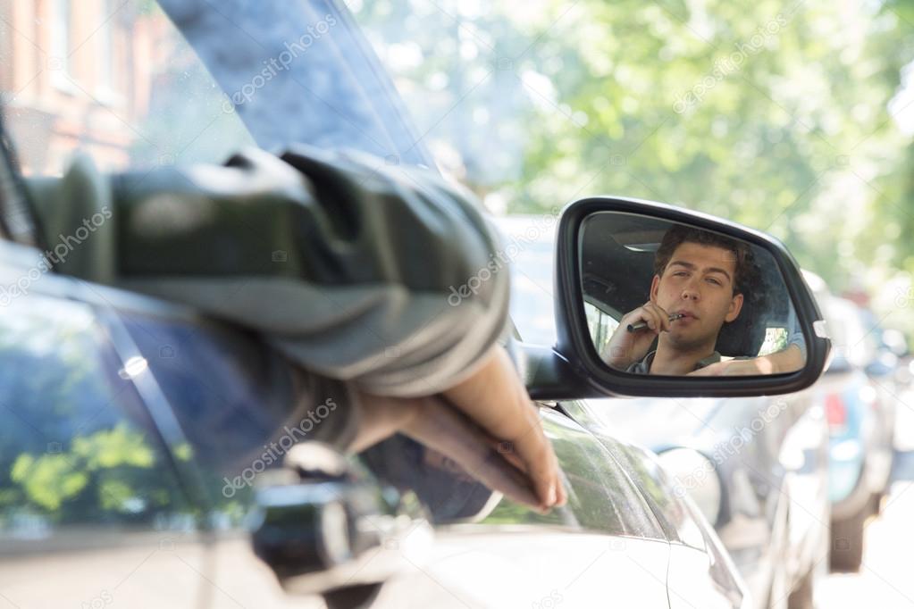 Young Man Reflection on Car Side Mirror