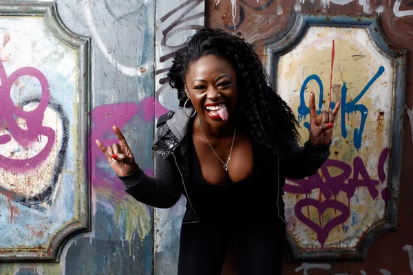 Laughing woman giving a horns gesture — Stock Photo, Image