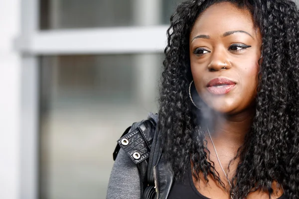 Young African woman smoking a cigarette — Stock Photo, Image