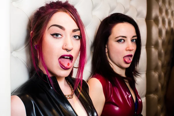 Two Stylish Young Woman Showing Tongue Piercing