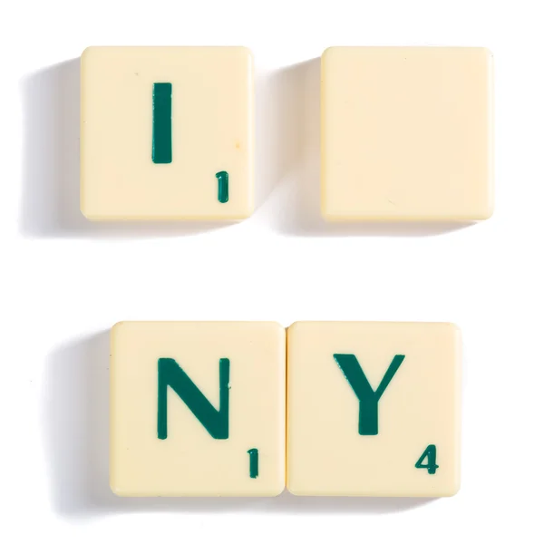 Scrabble lettera piastrelle per I concetto di Ny in bianco Immagini Stock Royalty Free