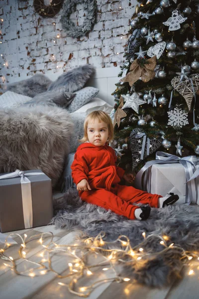 Little Girl Red Warm Sweater Sits Christmas Tree Toys Gifts — Stock Photo, Image