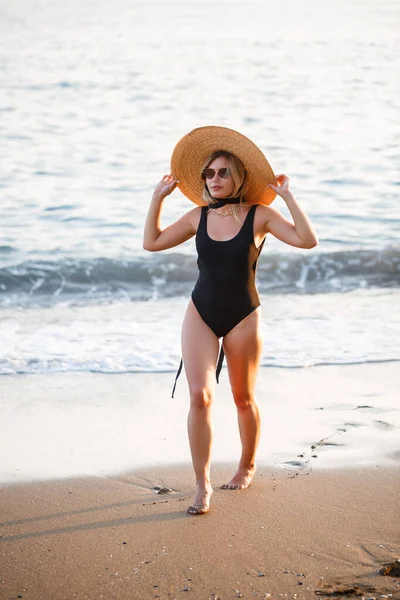 Mooi Meisje Een Zwart Badpak Hoed Een Zandstrand Aan Zee — Stockfoto