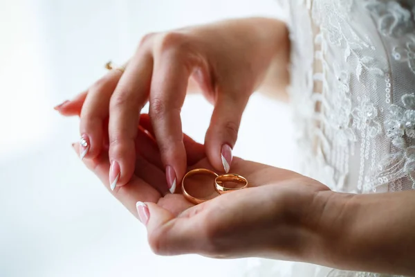 Golden wedding rings for newlyweds on their wedding day