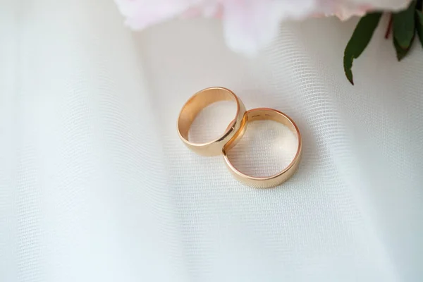 Golden wedding rings for newlyweds on their wedding day