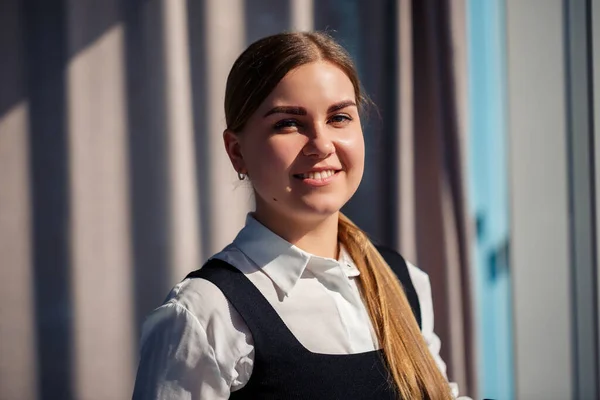 Confident business woman boss standing in modern office, female leader, business owner thinking about future success, planning new opportunities