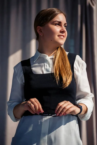 Confident business woman boss standing in modern office, female leader, business owner thinking about future success, planning new opportunities